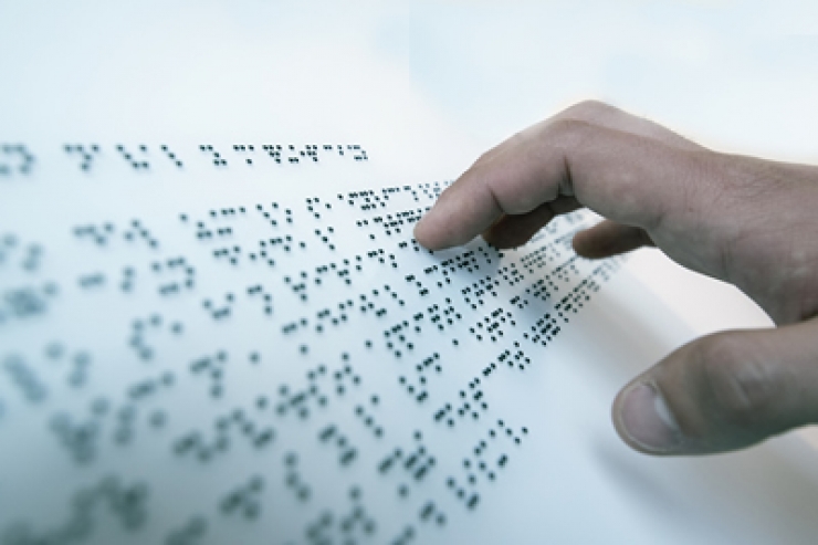 Una persona cega llegint en braille.